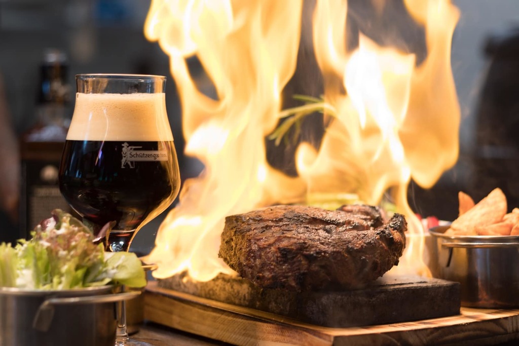 The Top 10 essential New York City eating experiences 3 cooked meat on wooden surface beside drink and foods in bowls
