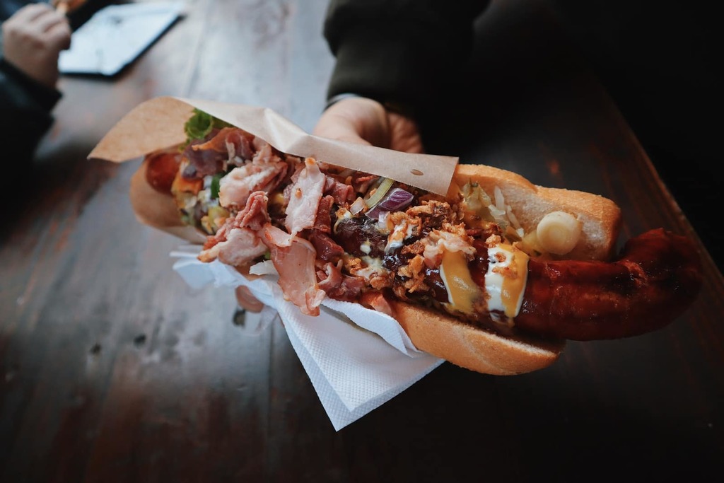 The Top 10 essential New York City eating experiences 2 person holding bun with hotdog