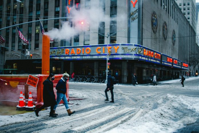 pexels-photo-7165335 anonymous people walking in snowy city during coronavirus pandemic