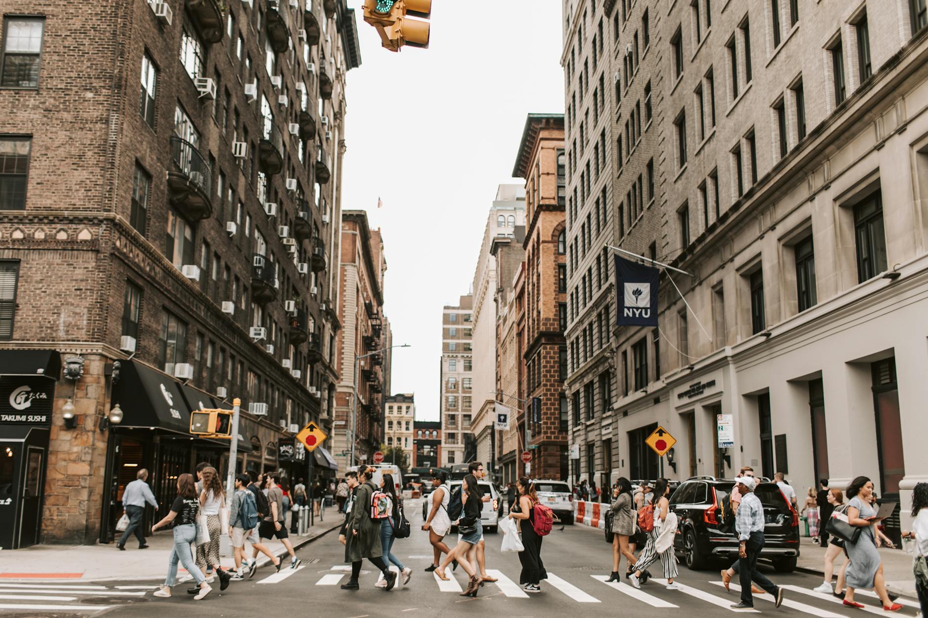 people crossing a street in new york