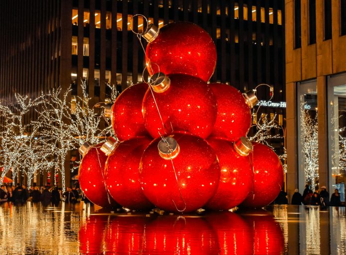 giant christmas balls on display over water fountain