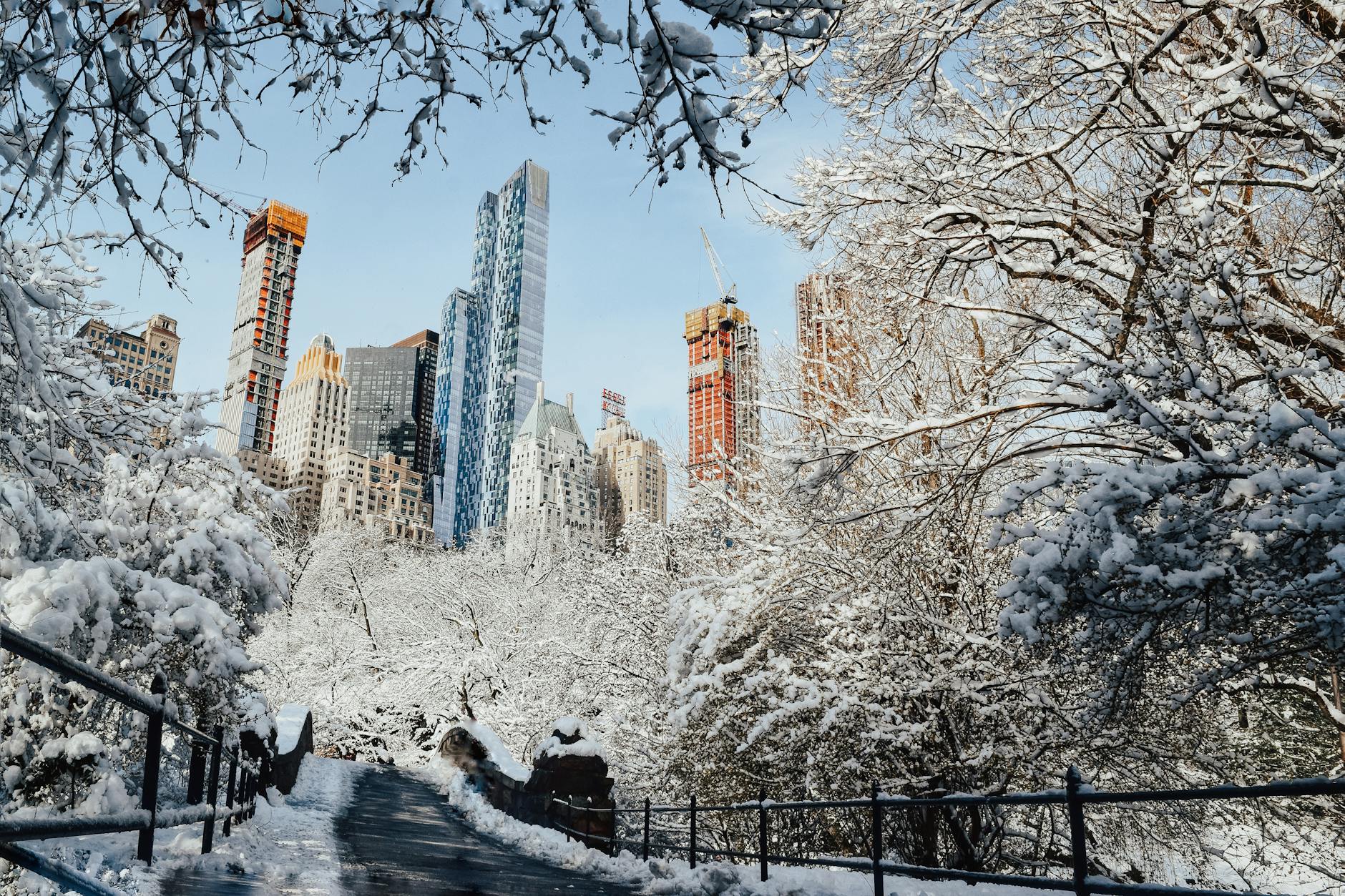 bridge in park covered with snow in wintertime