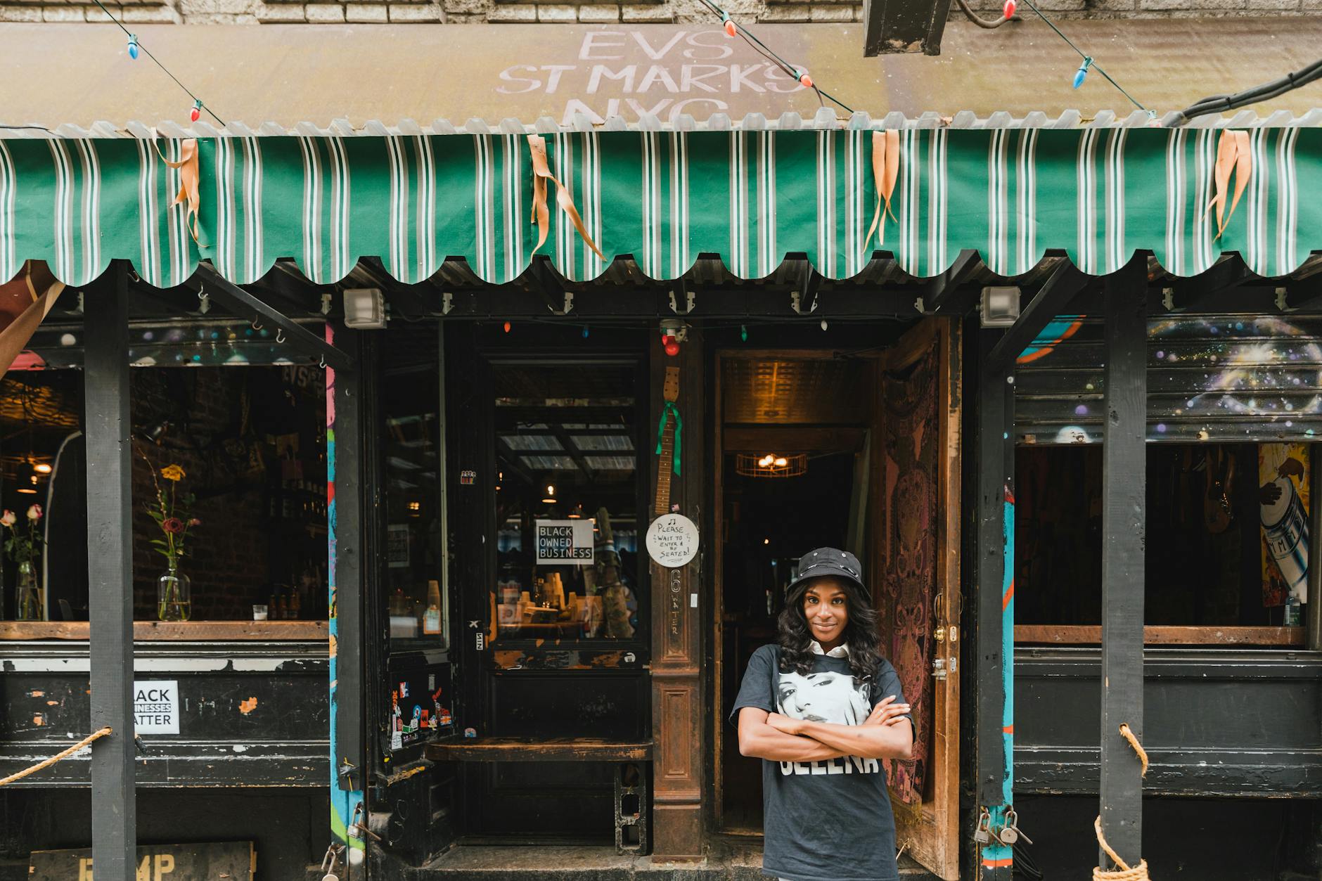 Things to do in New York in January to decompress from the festive December 6 portrait of smiling female owner in front of cafe