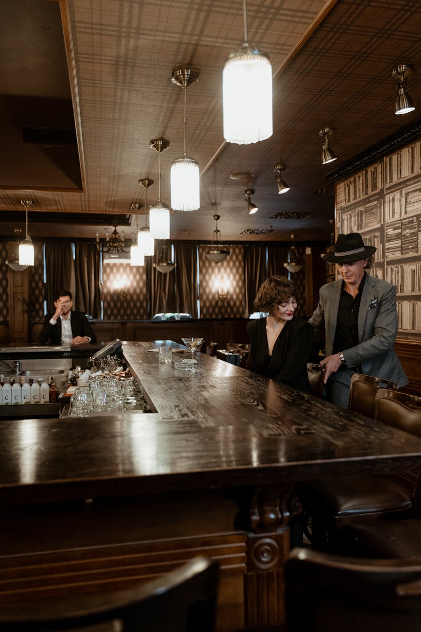 man and woman sitting at the bar