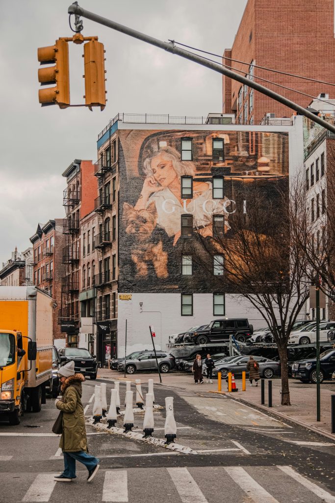 Urban street with large mural and pedestrian